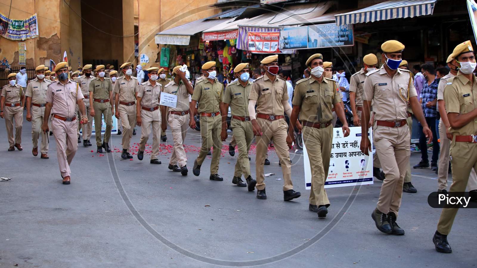 Policemen wear masks and hold banners to spread awareness on Covid-19 during a flag march organized in Ajmer, Rajasthan on July 02, 2020.