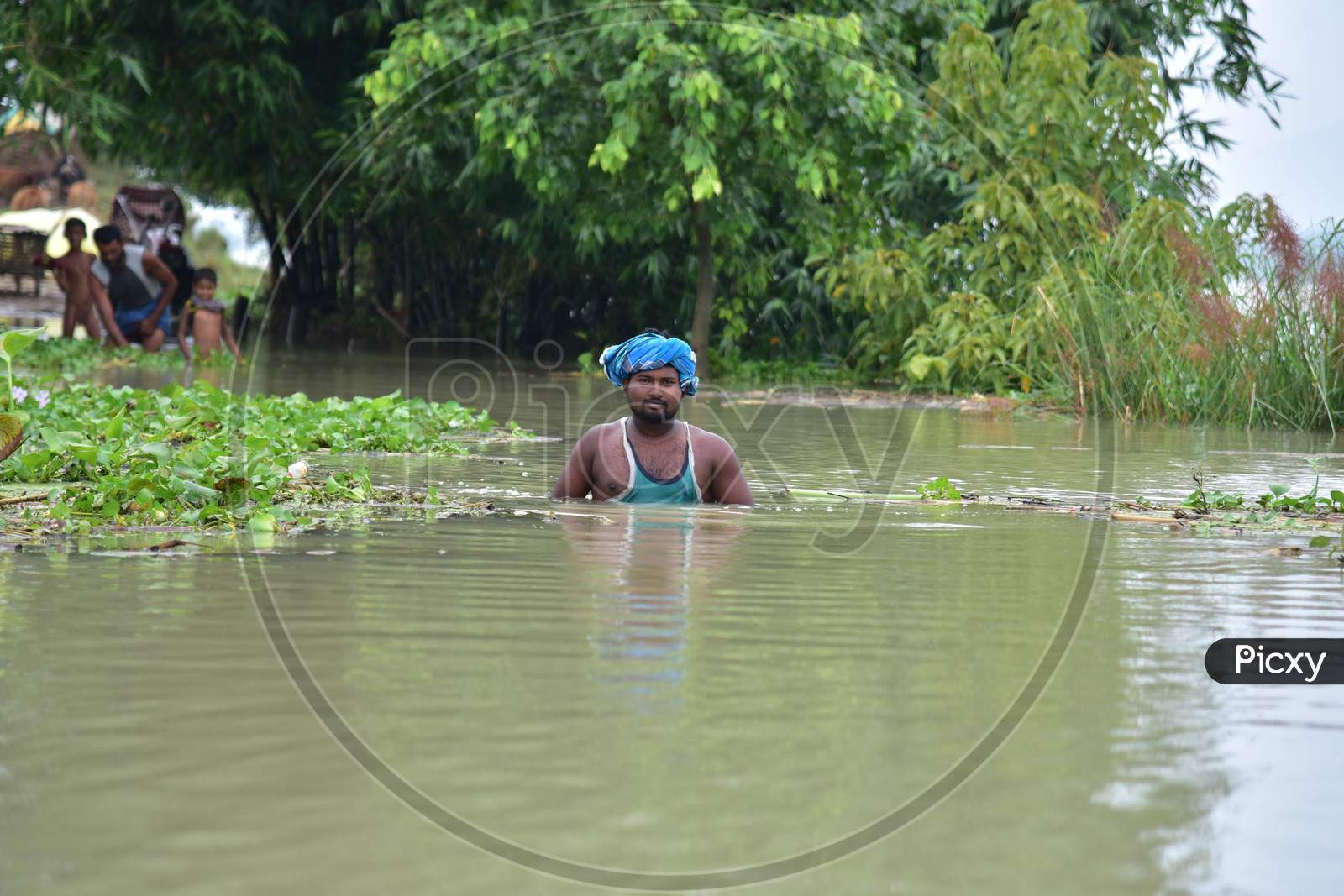 A man Wades Through The Flood Water At  Sildubi Village In Morigaon District Of Assam On June 29,2020.