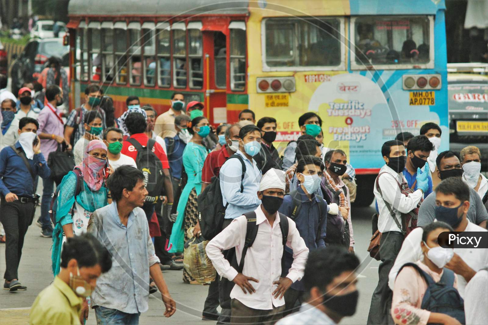 People wait to board a public bus, after the government eased a nationwide lockdown that was imposed as a preventive measure against the COVID-19 coronavirus, in Mumbai, India, on June 26, 2020.