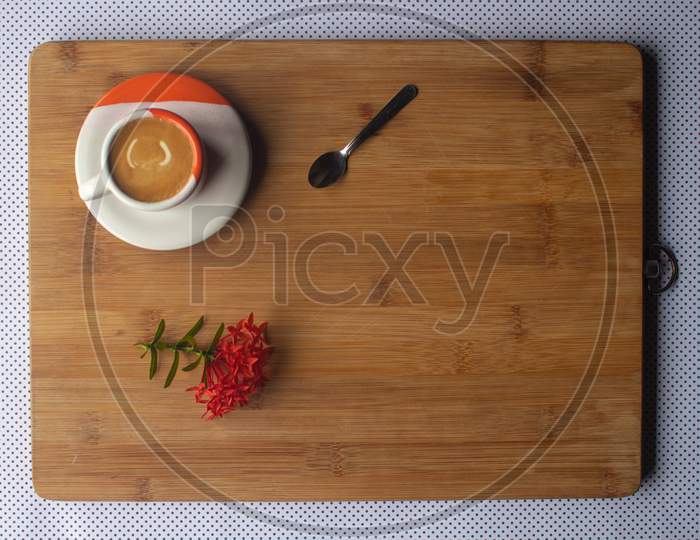 Freshly Brewed Sparkling Coffee In A Small Orange And White Mug. Cup With Typical Brazilian Drink On A Wooden Board. Copy Space.