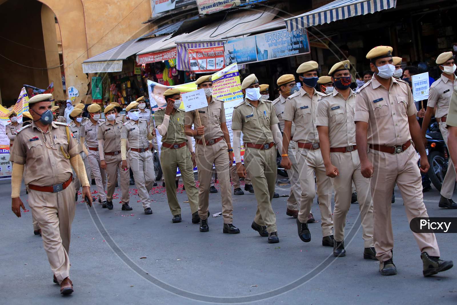 Policemen hold banners to spread awareness on Covid-19 during a flag march organized in Ajmer, Rajasthan on July 02, 2020.