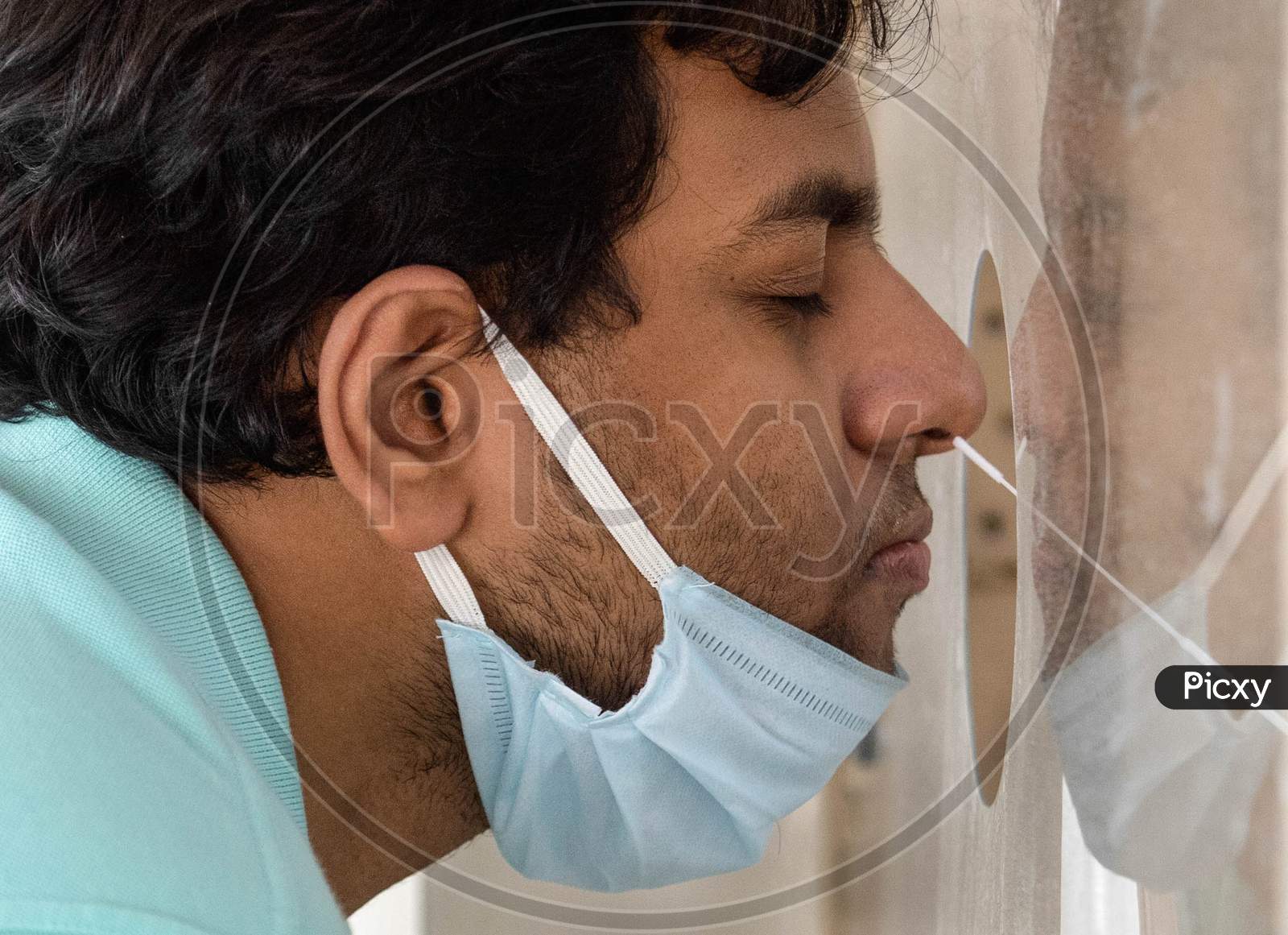 A Health Worker Collects Swab Sample From A Man For Covid-19 Antigen Test, At Mayur Vihar On June 29, 2020 In New Delhi, India.