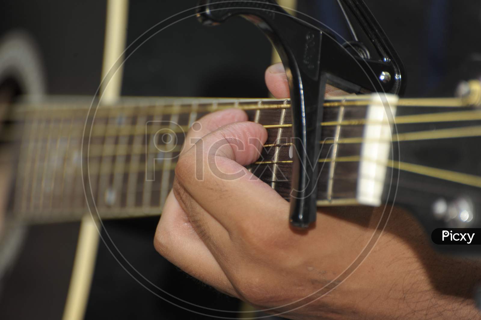 Fingers On The Fret Of A Guitar.