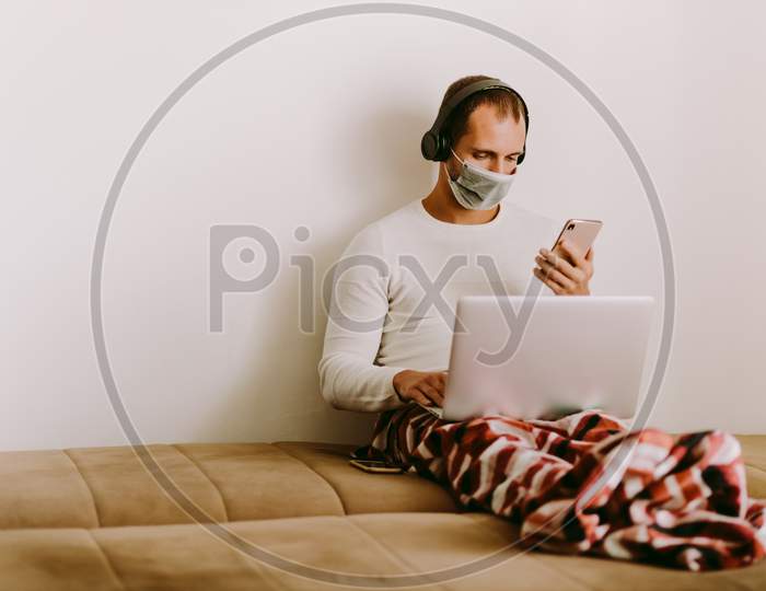 Man With Laptop And Smartphone During Quarantine At Home