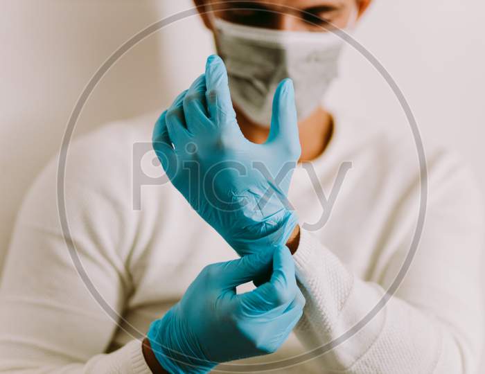 Man Wearing Latex Gloves And Face Mask