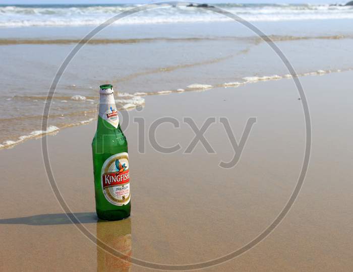 Alcohol or Beer Bottle on a Beach Shore