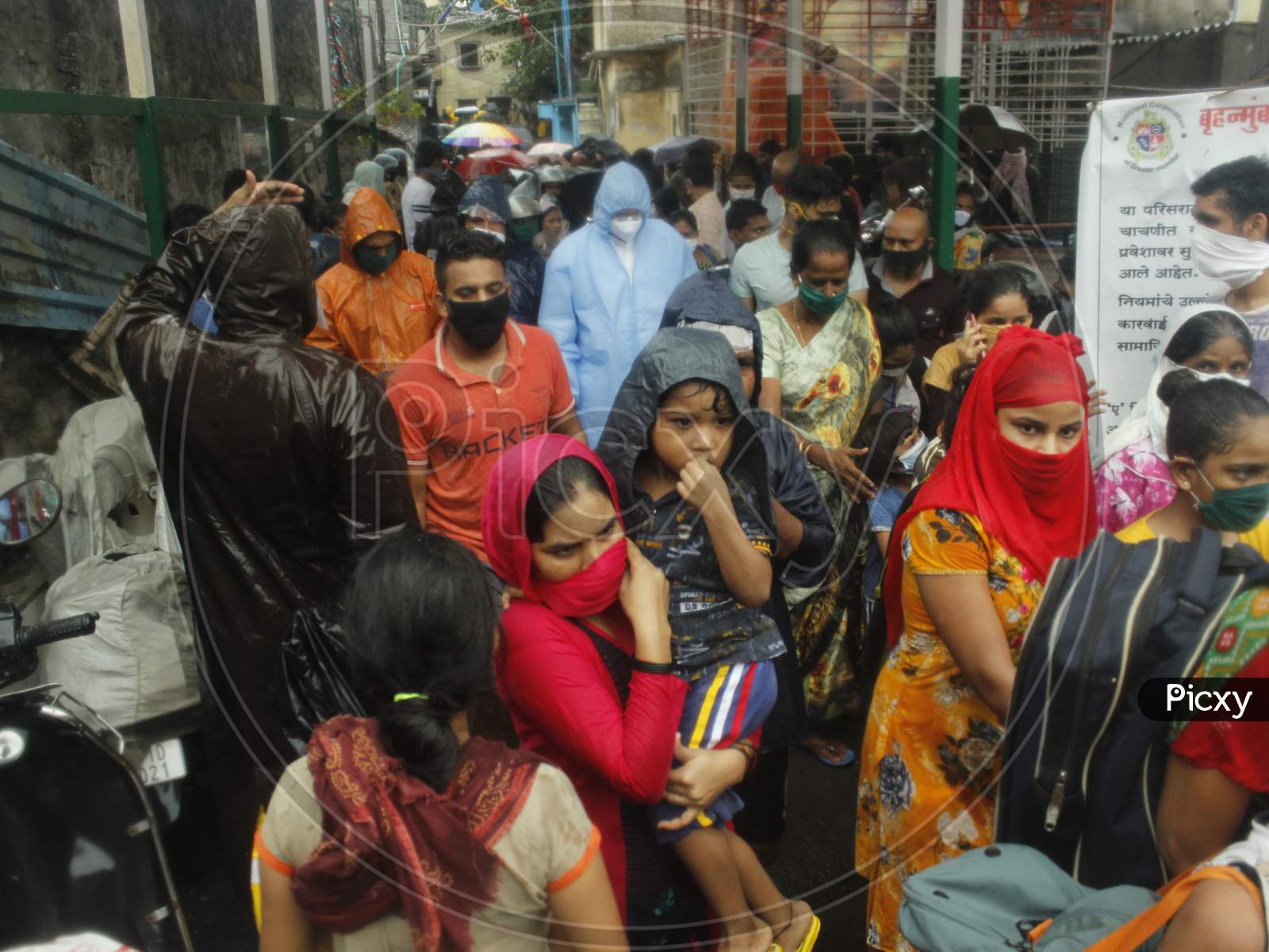 People wait to be evacuated from a slum off the coast of the Arabian sea as cyclone Nisarga makes its landfall on the outskirts of the city, in Mumbai, India, June 3, 2020.