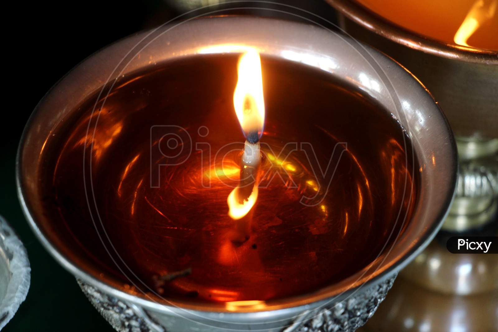 Close up shot of Lighted Diya Placed in a Sequence