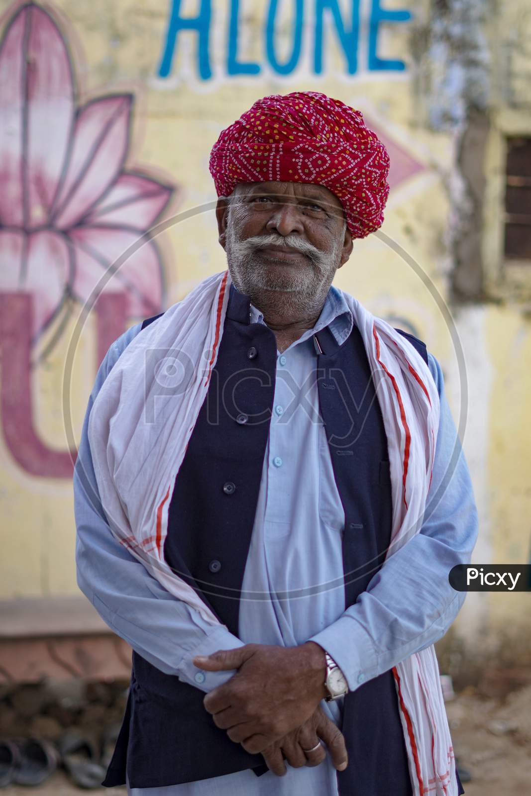 Pushkar, Rajasthan / India- June 5 2020 : Old Man In White Kurta Wearing A Turban Standing Looking Directly Into The Camera.