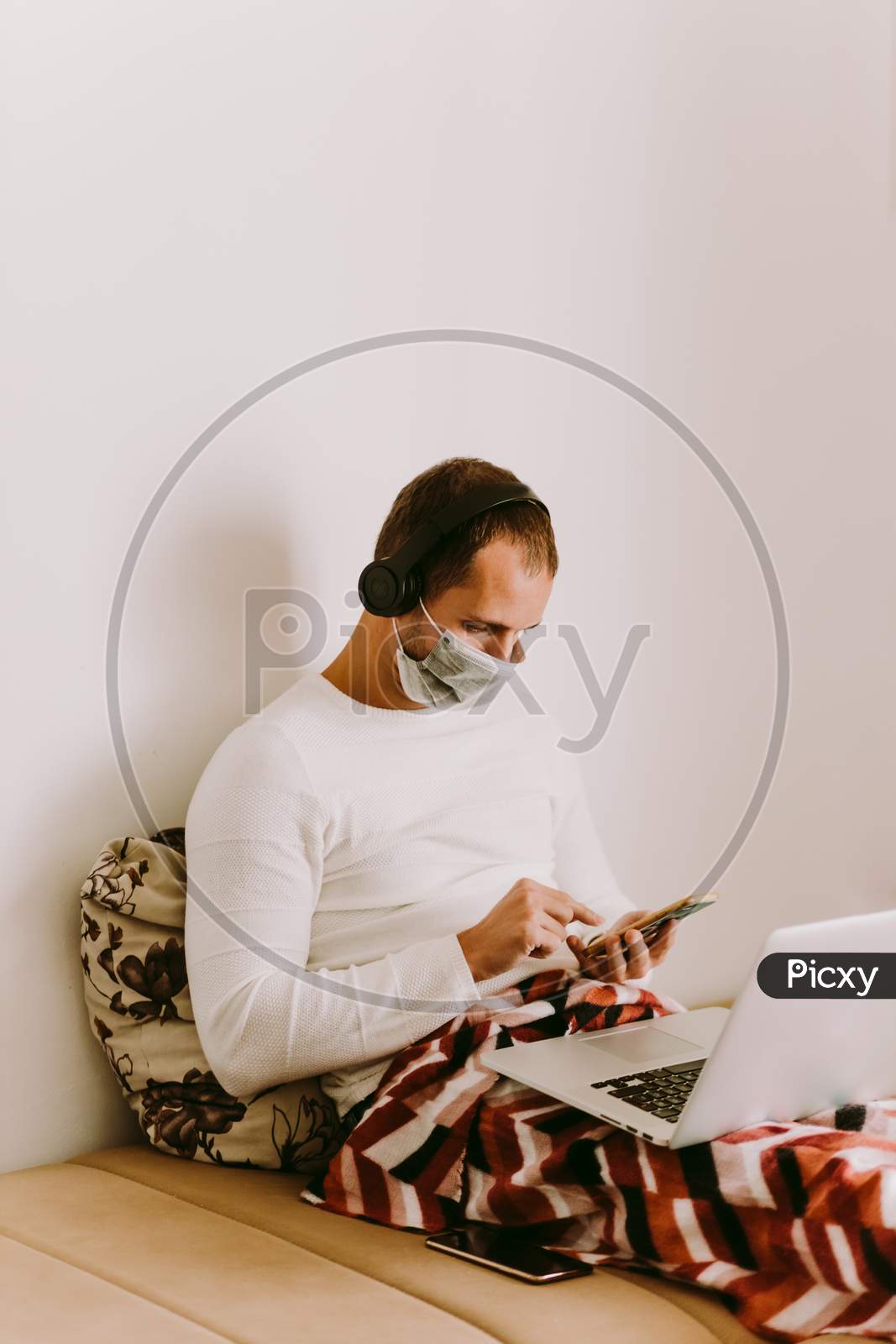 Man Using Laptop At Home During Quarantine At Home