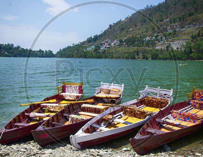 The picturesque Bhimtaal with the trademark boats by its shore in Uttarakhand, India.