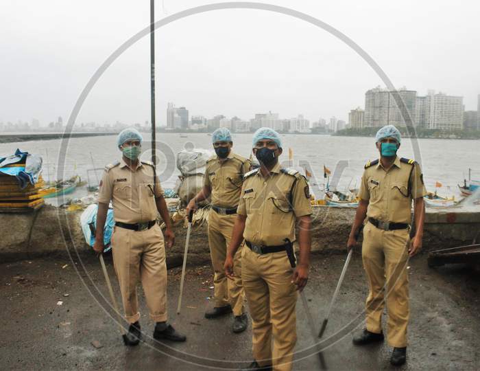 A Police team is deployed at outside slum area off the coast of the Arabian sea, in Mumbai, to evacuate the residents, as cyclone Nisarga makes its landfall, on the outskirts of the city, June, 3, 2020.