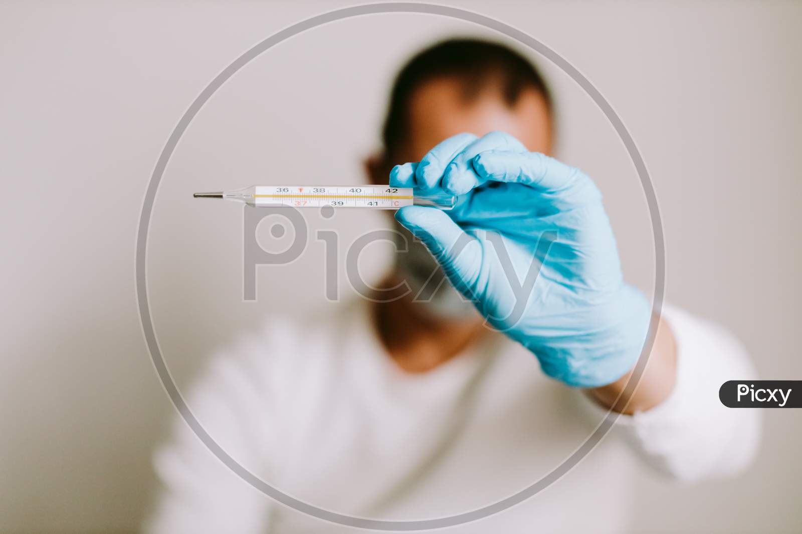 Man Measuring Temperature With Thermometer On Quarantine