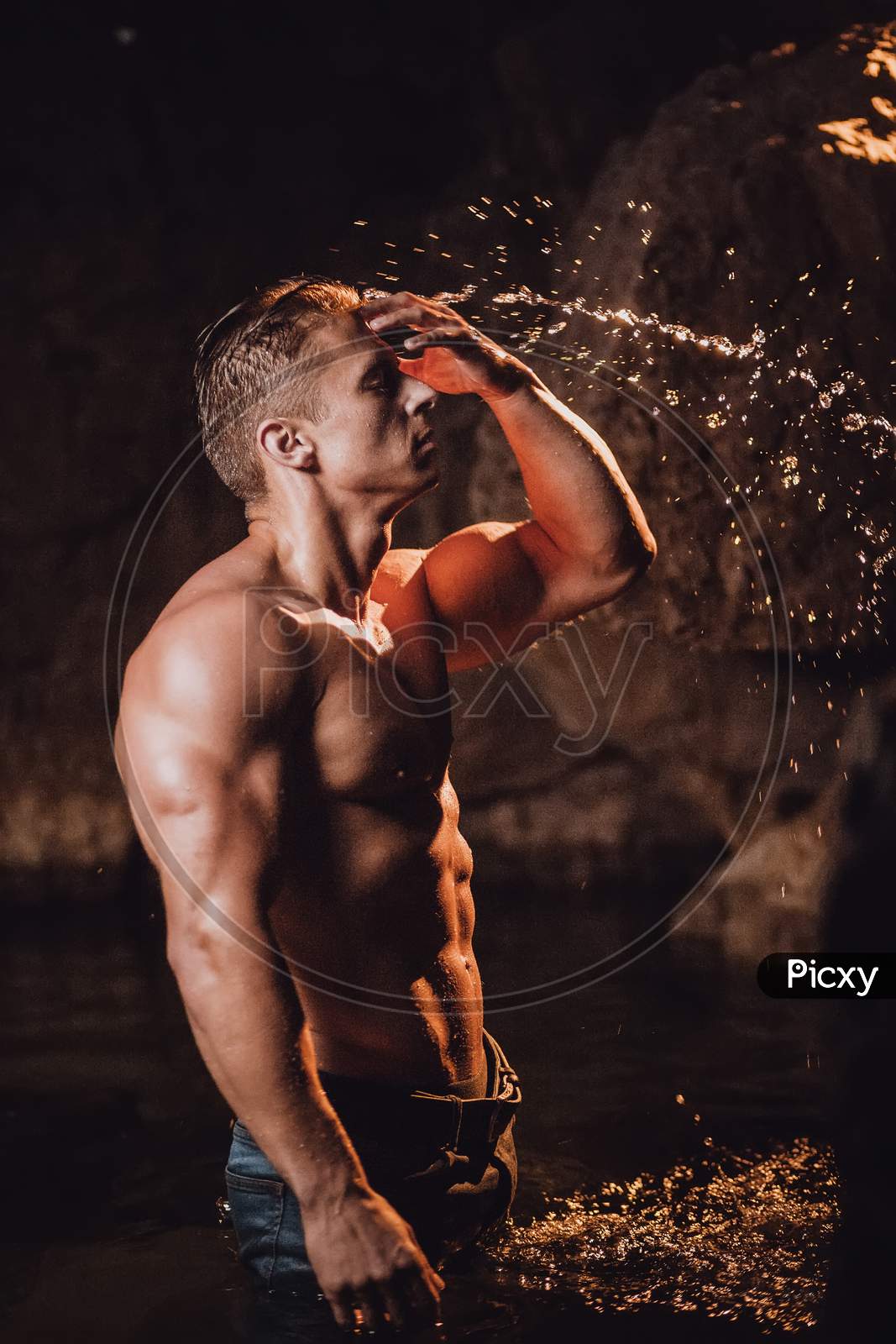 Sexy Muscular Man Splashing Water