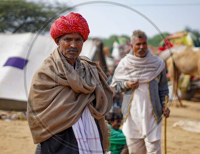 Pushkar, Rajasthan / India- June 5 2020 :A Portrait Of An Old Man With Red Turban In Pushkar During Camel Fair.