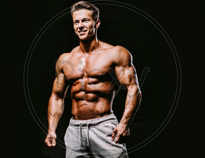 Muscular Attractive Man In Gym