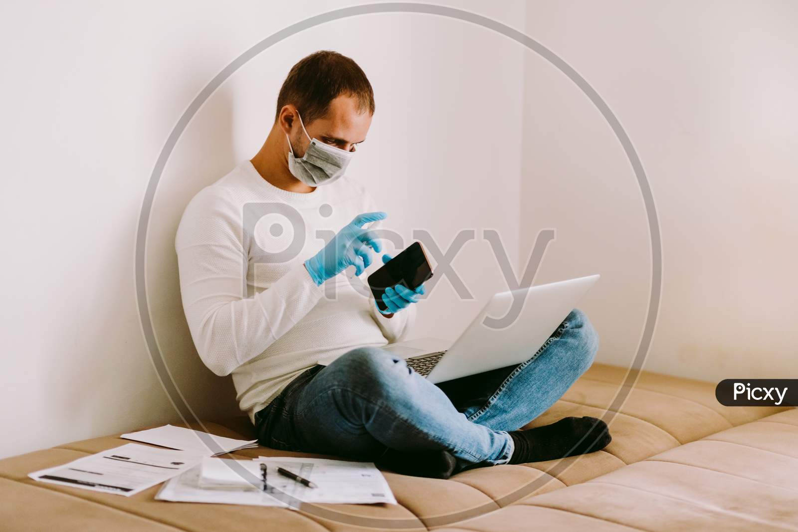 Man With Laptop And Smartphone During Quarantine At Home
