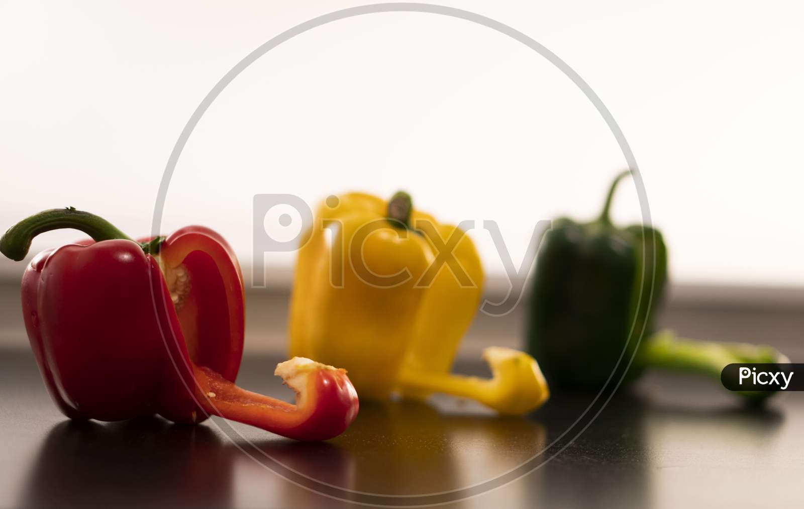 A beautiful image of the yellow, red and green bell peppers (Capsicums).