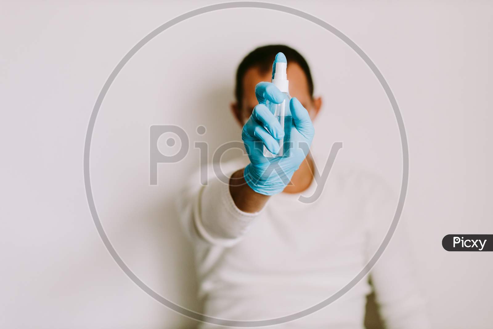 Man Using Liquid Hand Sanitizer During Quarantine At Home