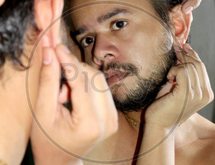 Young Sexy Man Checking His Ear On Mirror