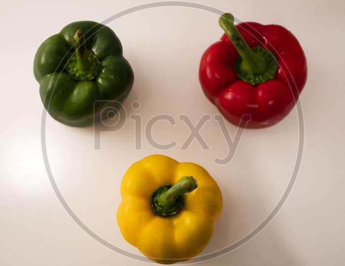 A beautiful image of the yellow, red and green bell peppers (Capsicums).