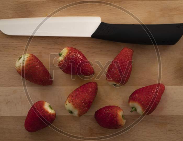 Red and Juicy Strawberries with a knife.