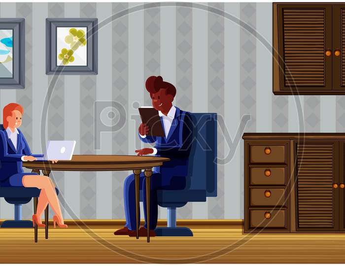 Couple Sitting In Living Room And Using Electronic Devices