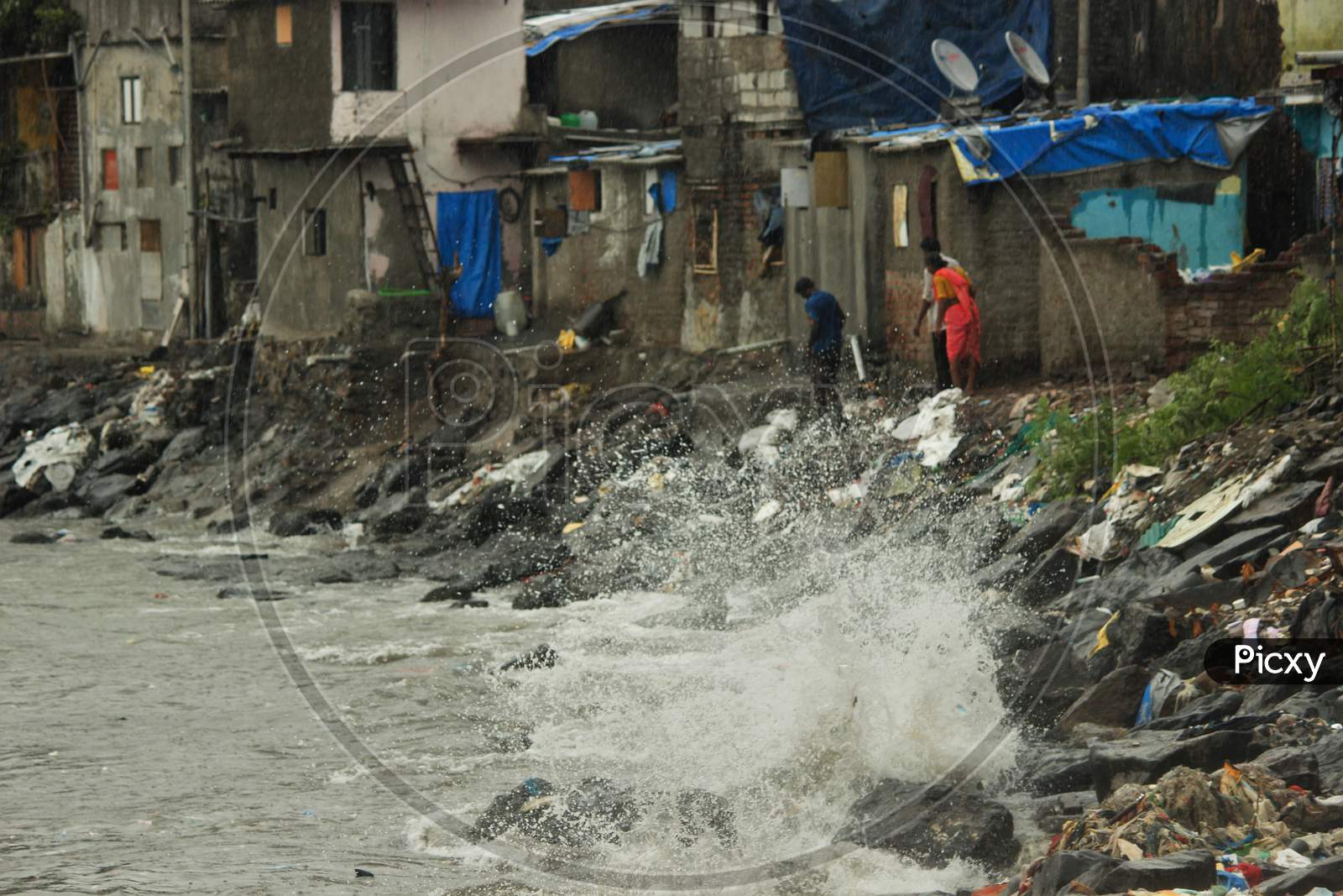 Sea waves strike at a slum area near the Arabian sea as cyclone Nisarga makes its landfall on the outskirts of the city, in Mumbai, India, June 3, 2020.