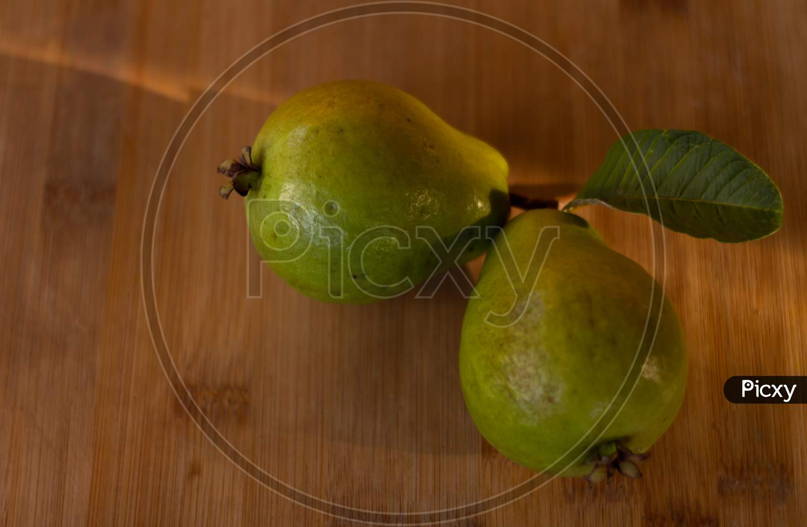 Two Guavas On A Wooden Table. Free Space To Write. Food For Vegetarians And Vegans.