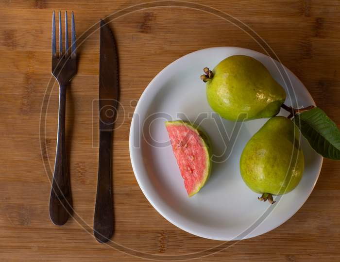 Two Guavas On A Wooden Table. Free Space To Write. Tropical Fruit From Brazil.