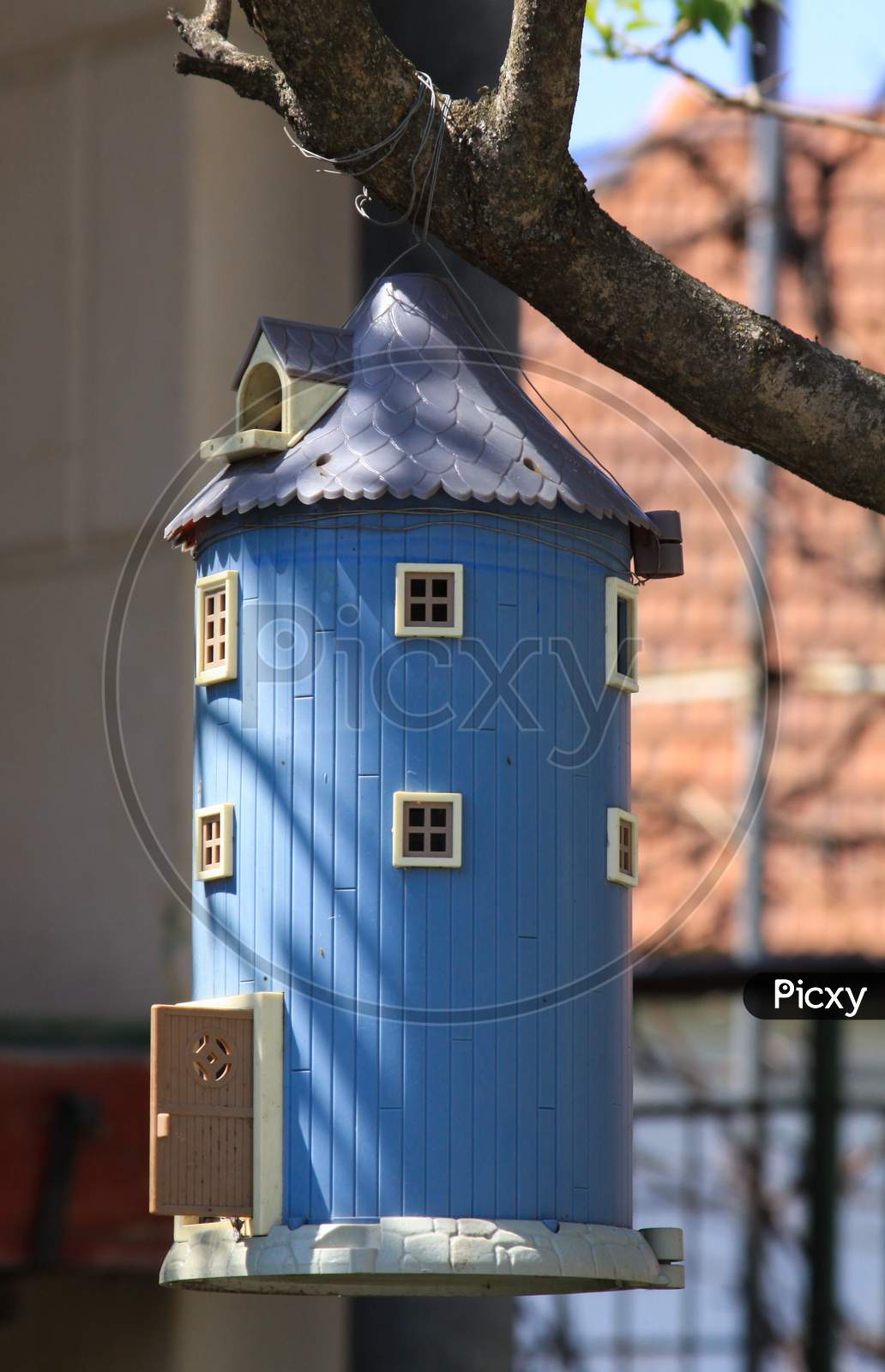Blue Birdhouse Shaped Like A Miniature Barn