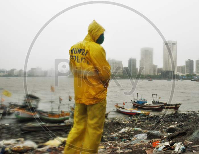 A Mumbai police official stands guard off the coast of the Arabian sea in Mumbai as cyclone Nisarga makes its landfall, on the outskirts of Mumbai, India, June 3, 2020.