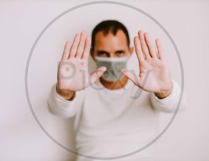 Man Showing Clean Hands And Wearing Face Mask On Qurantine