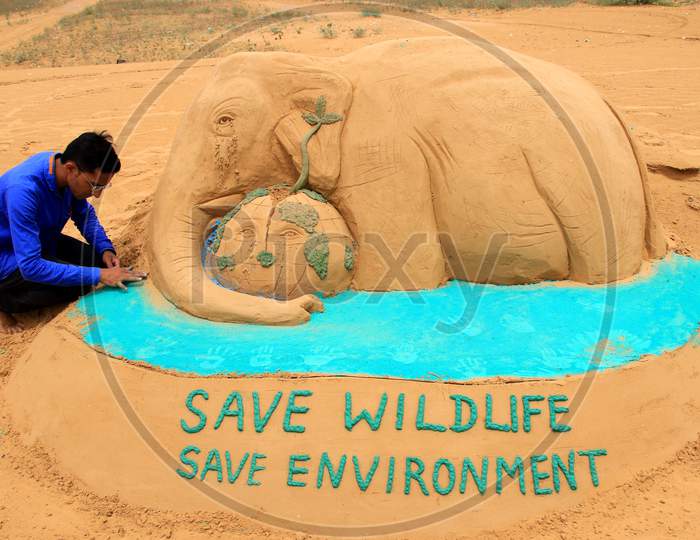 Sand Artist Gives Final Touches To Sand Sculpture Of An Elephant, Representing The Recently Killed Wild Pregnant Elephant Of Kerala, With The Message 'Save Wildlife Save Environment', On The Eve Of World Environment Day, In Pushkar, Rajasthan, India On 04 June 2020.