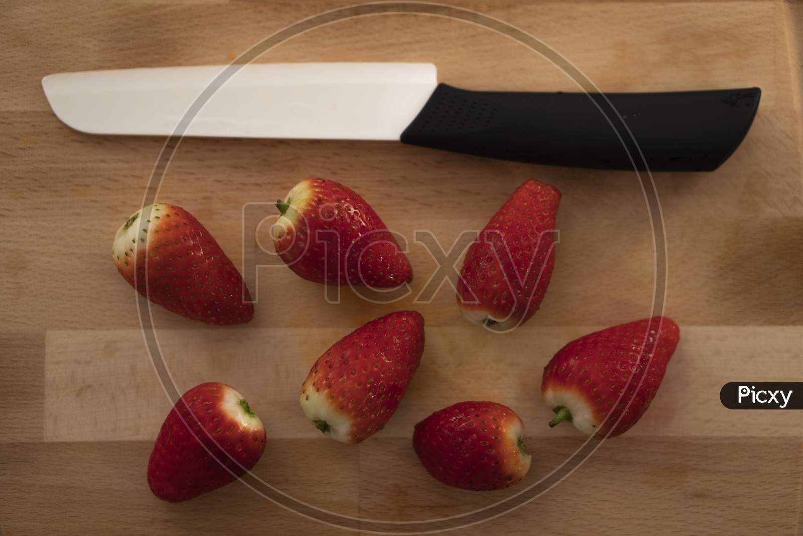 Red and Juicy Strawberries with a knife.