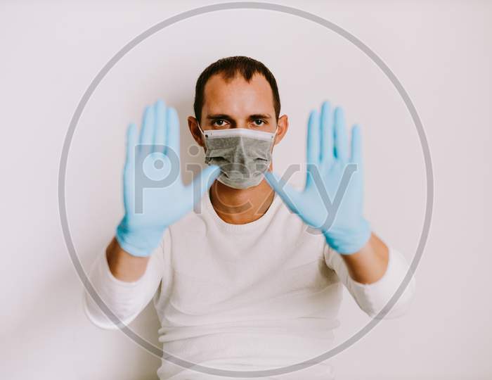 Man Wearing Latex Medical Gloves And Face Mask