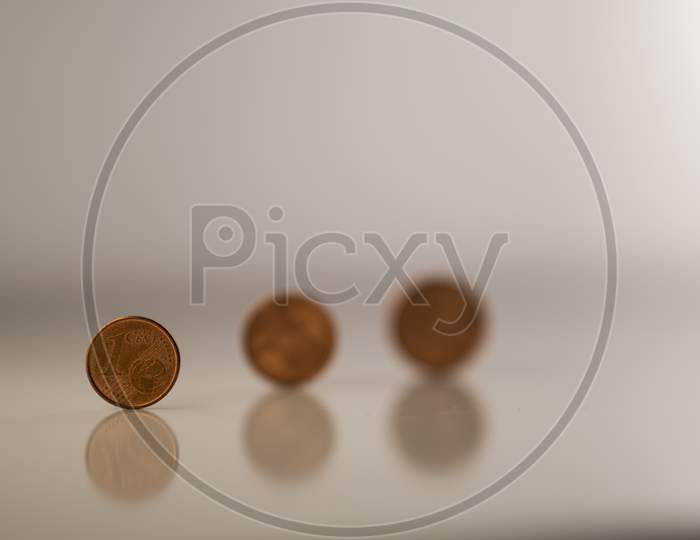 European cents (Coins) against a white background to highlight the collapsed World economy (Global recession) during Covid-19 (Coronavirus) pandemic through the vision of the economists.