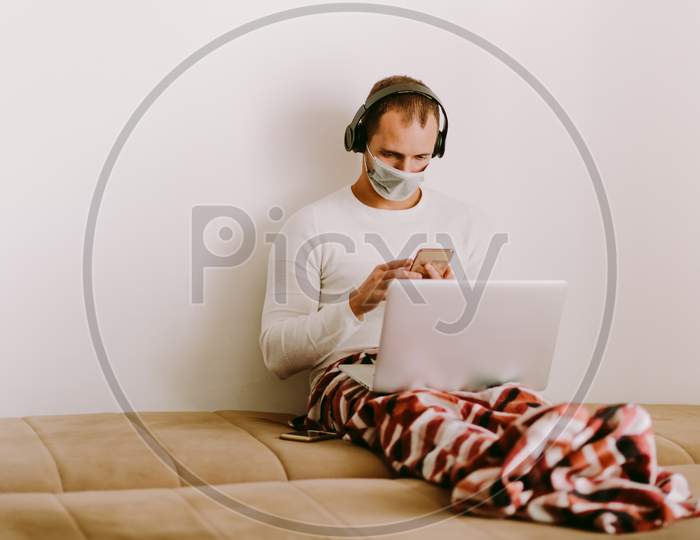 Man Working At Home And Wearing Face Mask For Virus Prevention