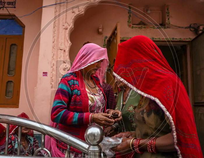 Pushkar, Rajasthan / India- June 5 2020 : Two Mid Aged Women In Veil Standing Near The Entrance Of Their Homes.