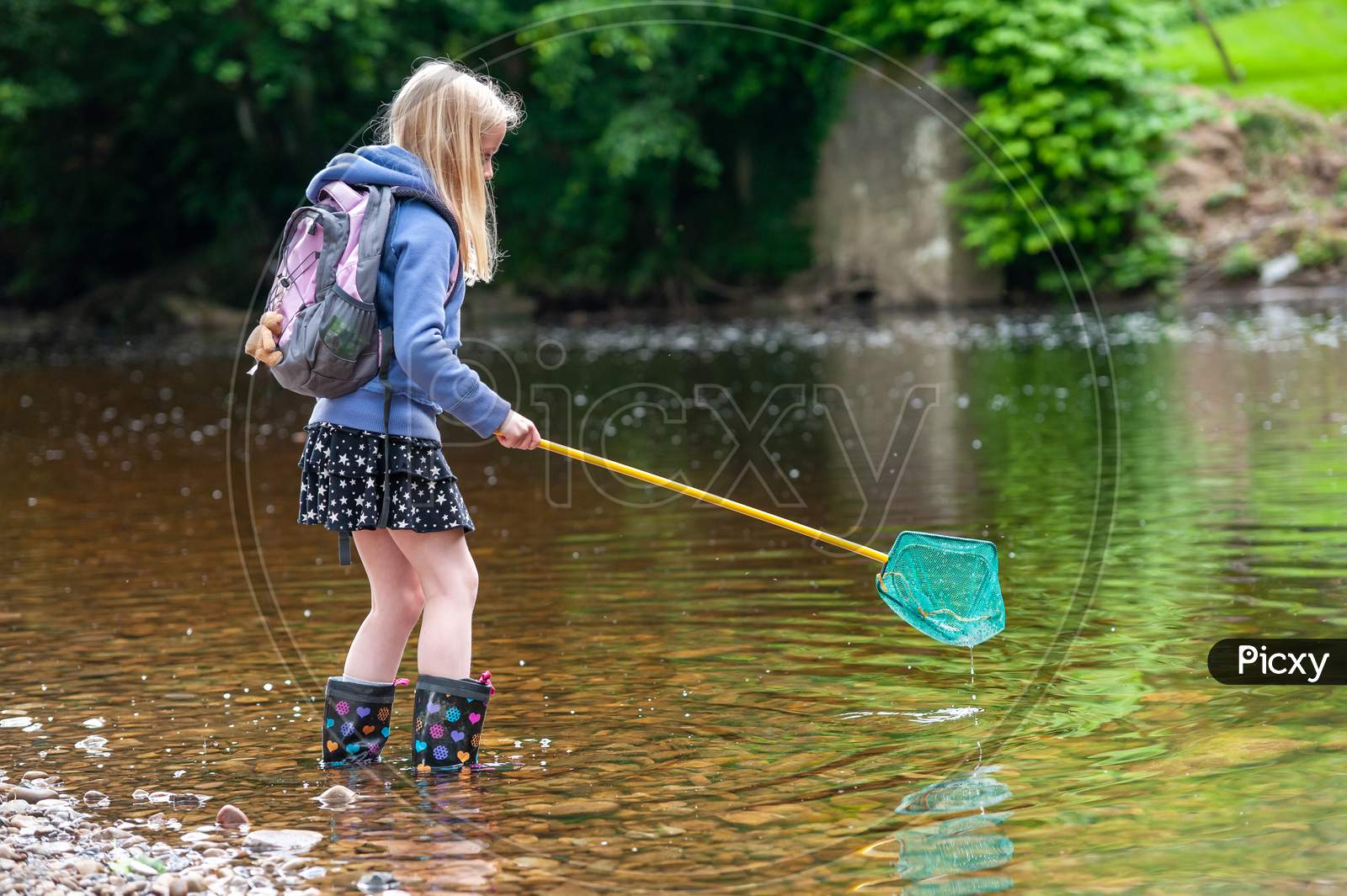 Young Blonde Girl Wish Fishing Net Wading Into River