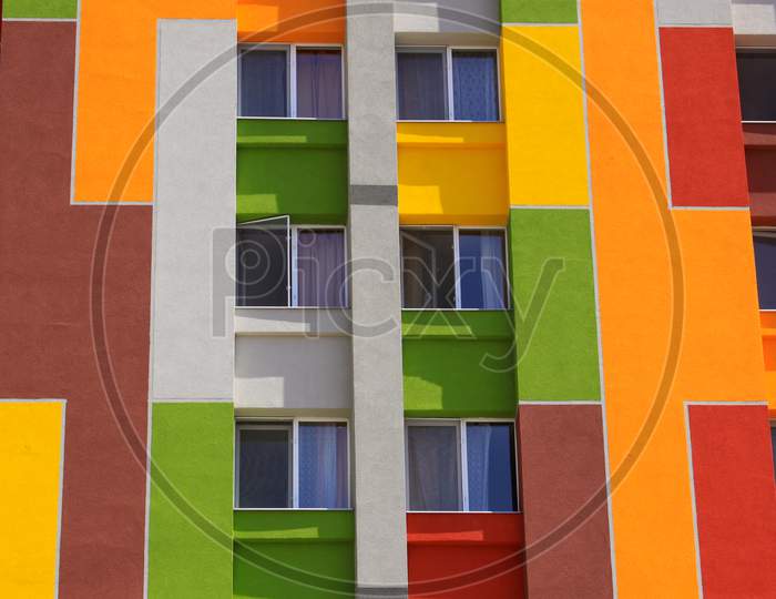 Colored Building Wall With Apartment Windows