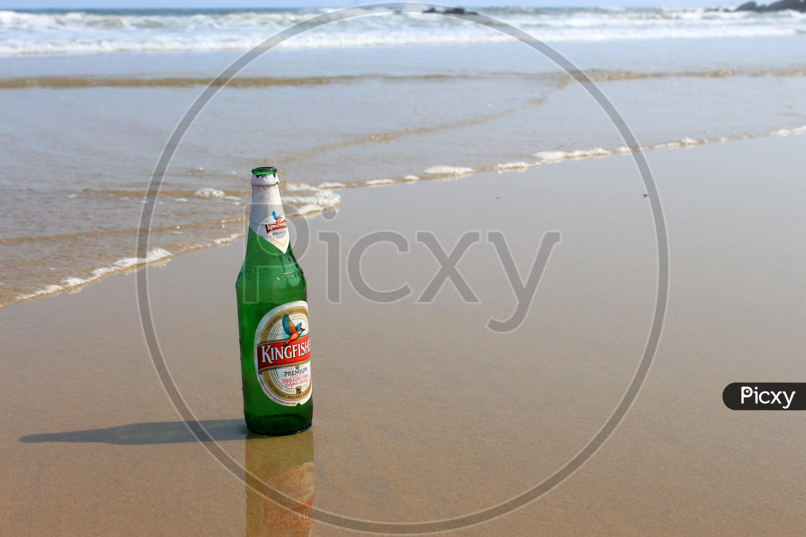 Alcohol or Beer Bottle on a Beach Shore