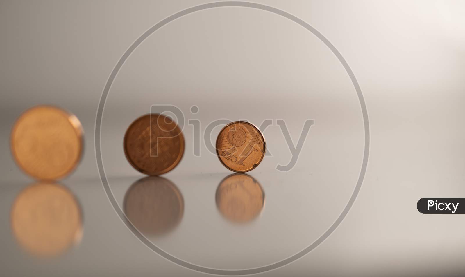 European cents (Coins) against a white background to highlight the collapsed World economy (Global recession) during Covid-19 (Coronavirus) pandemic through the vision of the economists.