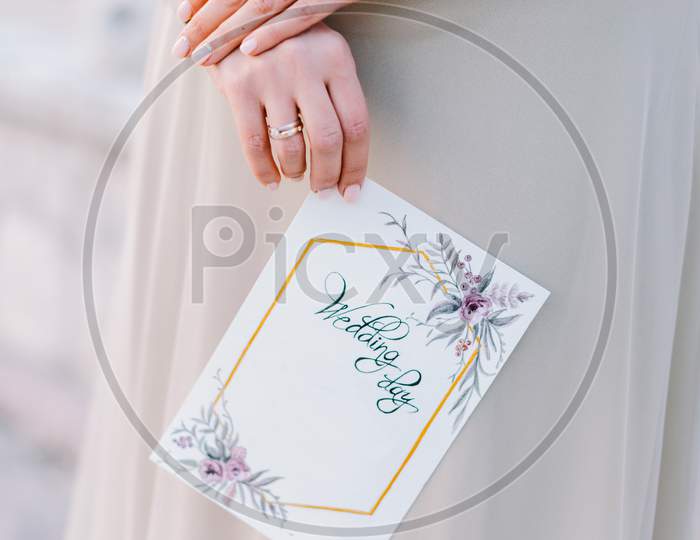 Bride Holding Wedding Invitation Card