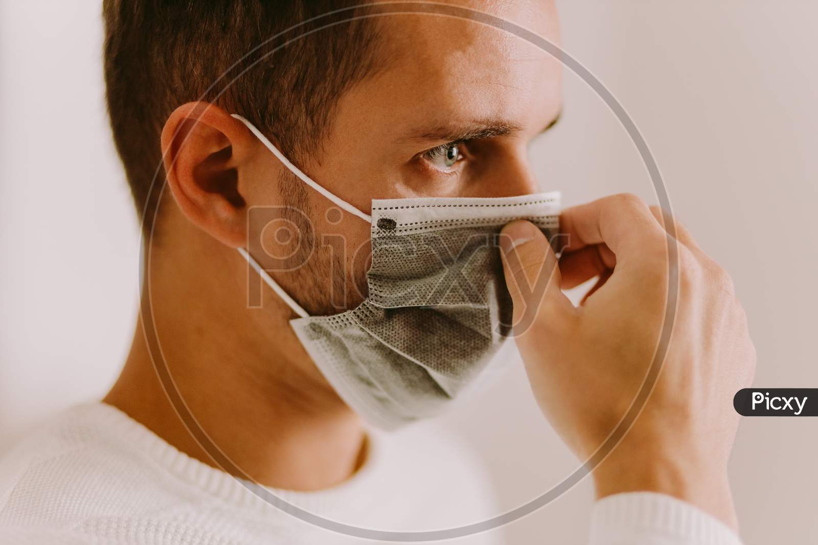 Man Using Face Mask  For Virus Prevention Measures On Quarantine At Home