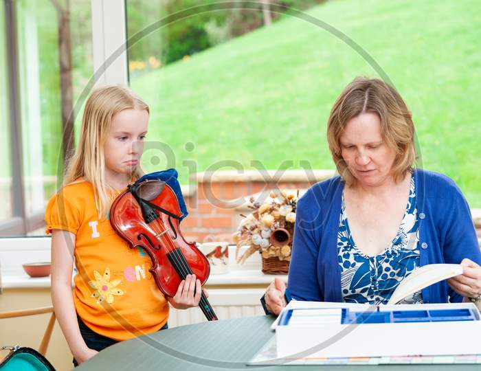 Little Girl Unhappy With Her Mother And Pushing Out Her Lower Lip During Violin Practice