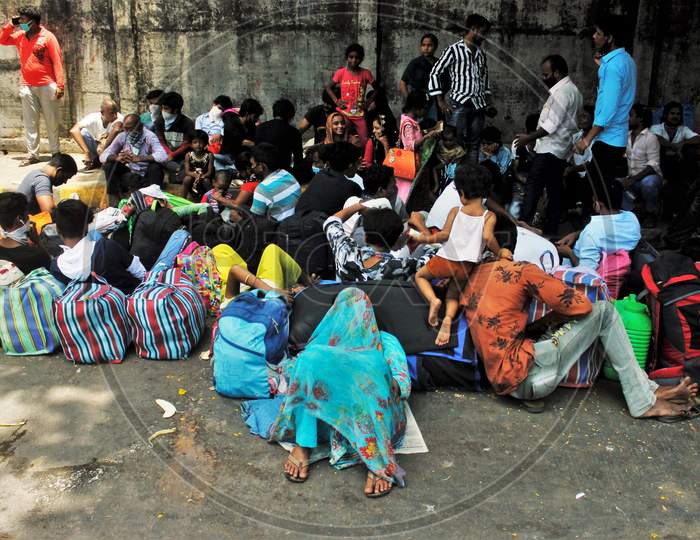People wait outside Chhatrapati Shivaji Maharaj Terminus(CSMT) to board a train that will take them to their home state during an extended lockdown to slow the spreading of the coronavirus disease (COVID-19), in Mumbai, India on May 27, 2020.