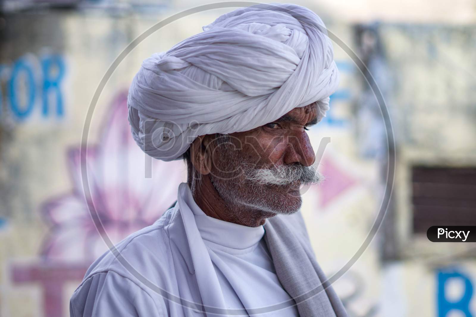 Pushkar, Rajasthan / India- June 5 2020 : An Old Man Standing In White Turban And White Kurta.