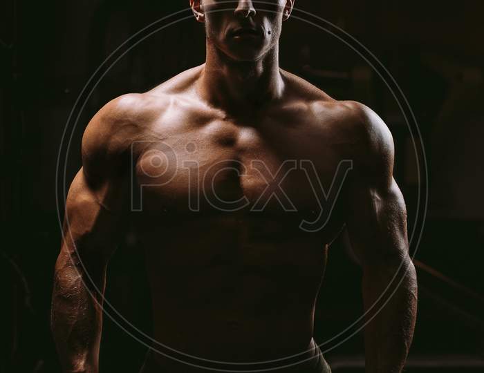 Silhouette Of Muscular Man In Gym