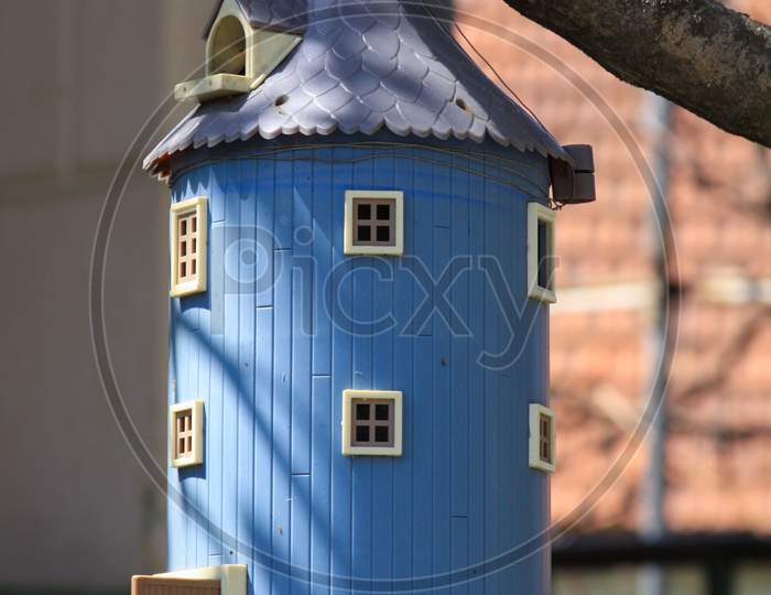 Blue Birdhouse Shaped Like A Miniature Barn